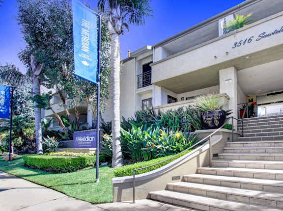 A building with a sign at Meridian Apartments, Los Angeles