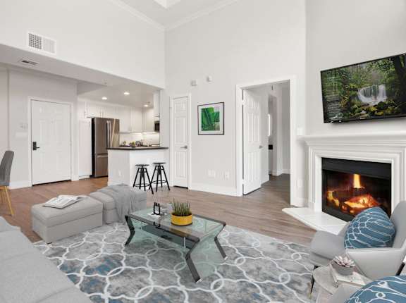 A modern living room with a fireplace and a glass coffee table at Toluca Court, Toluca Lake