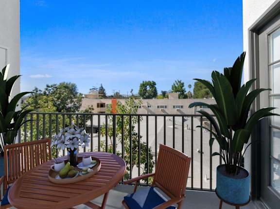 A balcony with a table, chairs, and potted plants at Toluca Court, California