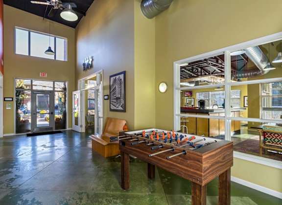 a game room with a foosball table and a chair at Village Club of Royal Oak, Royal Oak, 48067