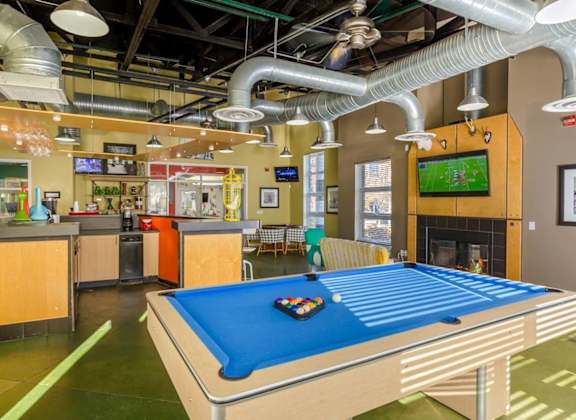 a game room with a pool table and a tv at Village Club of Royal Oak, Royal Oak, 48067