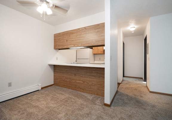 a dining room and kitchen with a table and chairs