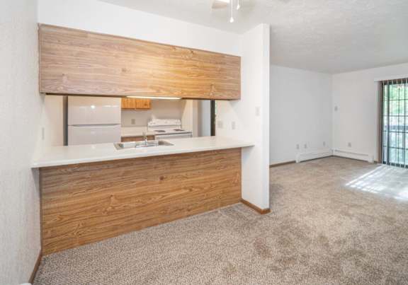 a dining room and kitchen with a table and chairs
