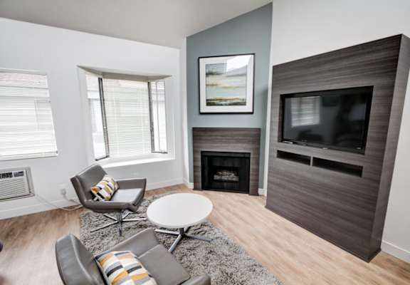 a living room with a fireplace and a tv at El Greco Lofts, Los Angeles, California