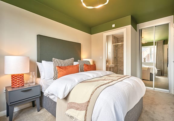 a bedroom with green ceilings and a large bed