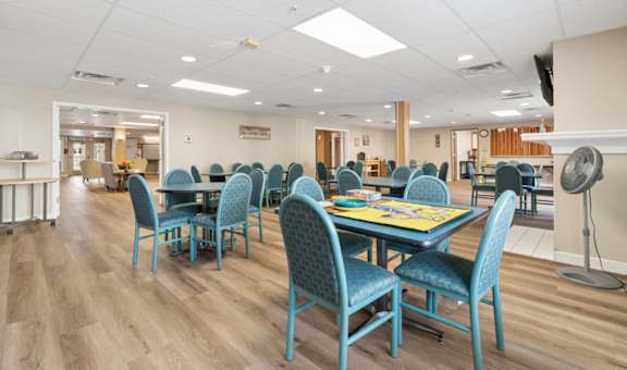 A room with a long table and chairs.