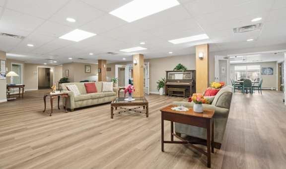 A spacious living room with wooden floors and furniture.