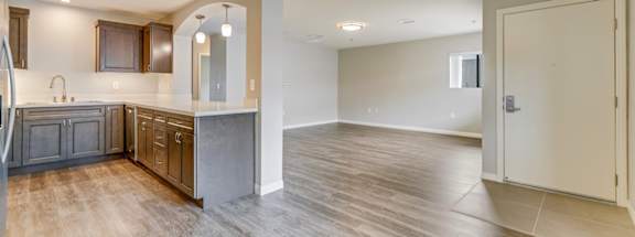 A spacious kitchen with wooden floors and a large island.