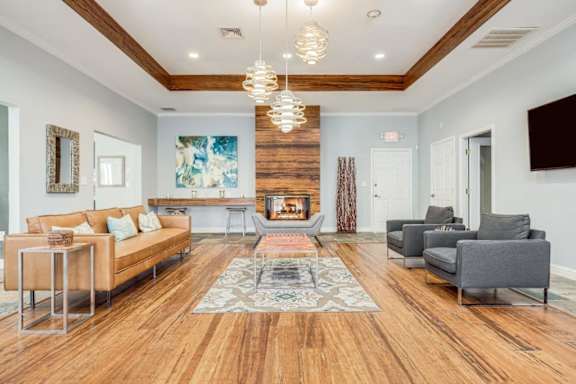 a living room with couches and chairs and a fireplace