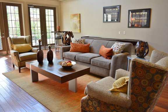 A living room with a grey couch and a coffee table.at Riverview Landing @ Valley Forge, Eagleville, PA