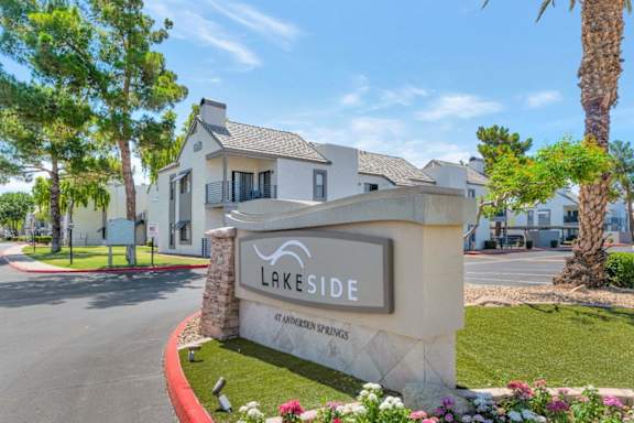 A sign for Lakeside Apartments is in front of a building.