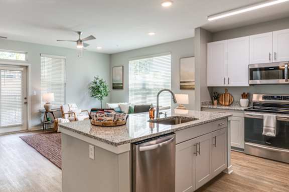 a large kitchen with a large island in the middle