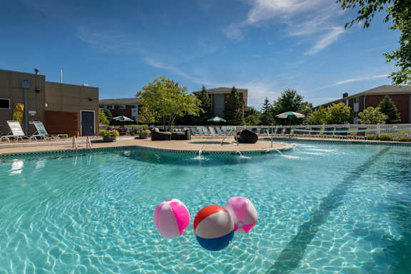 our apartments have a large swimming pool with balloons in it at Village Club of Royal Oak, Michigan