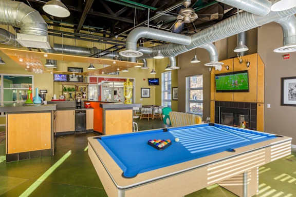 a game room with a pool table and a tv at Village Club of Royal Oak, Royal Oak Michigan