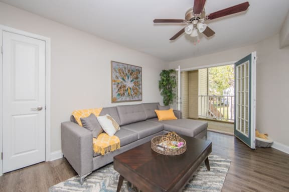 Living room with outdoor access at Villages at City Center apartments in Newport News VA