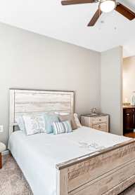 a bedroom with a bed and a ceiling fan