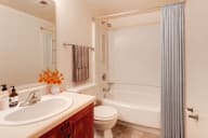 A virtually staged bathroom with a sink toilet and bathtub