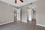A room with a ceiling fan and light fixture.