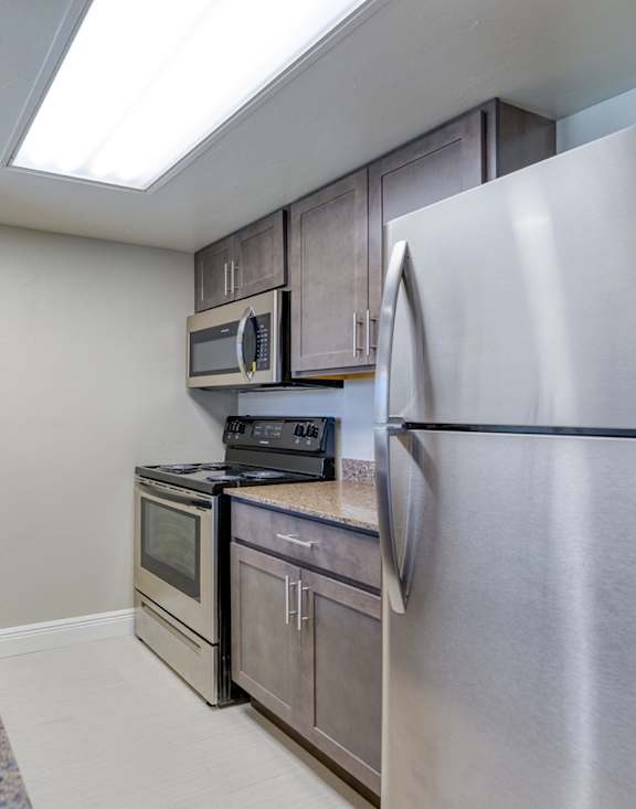 a kitchen with stainless steel appliances and granite counter tops