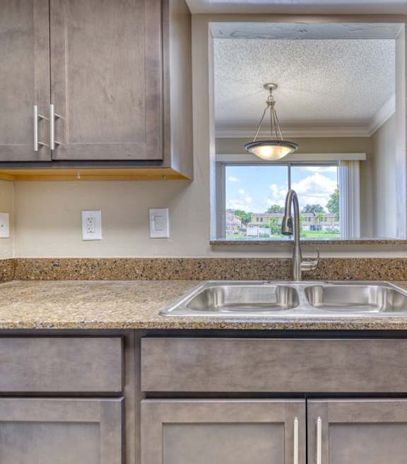 an empty kitchen with a sink and a window