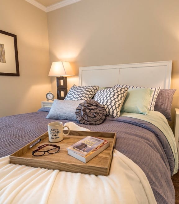 a bedroom with a tray on top of a bed