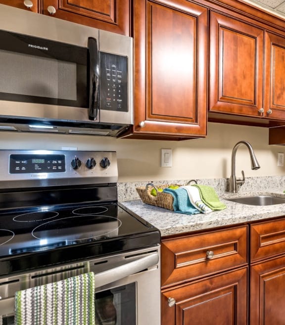 a kitchen with stainless steel appliances and wooden cabinets