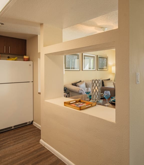 a view of a reception area with a white counter and a wall with geometric patterns