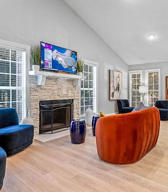 a living room with a fireplace and a tv above it