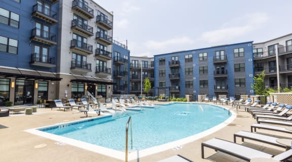 Vast outdoor pool with sundeck as an amenity for residents at Woodburn Exchange in Cincinnati, Ohio