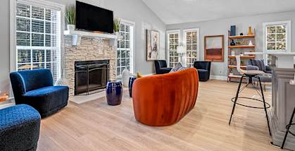 A living room with a fireplace and a television.