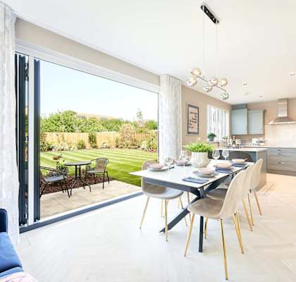 a kitchen and dining room with a table and chairs