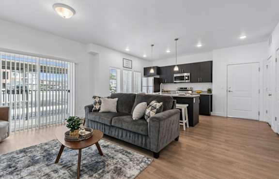 A modern living room with a grey sofa and a coffee table.