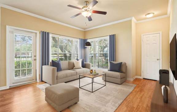 A living room with a sofa and ceiling fan at Reserve at Canyon Creek, San Antonio, TX