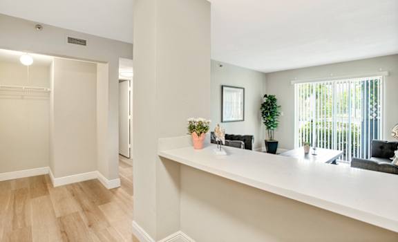 a living room with a long counter and a large window