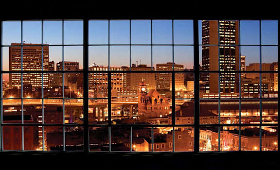 a view of the city at night from a window