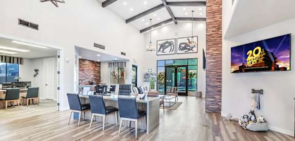 A modern living room with a dining area and a flat screen TV.