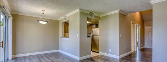 an empty living room with a hard wood floor