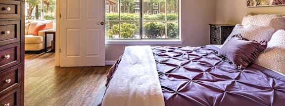 a bedroom with a bed and a large window