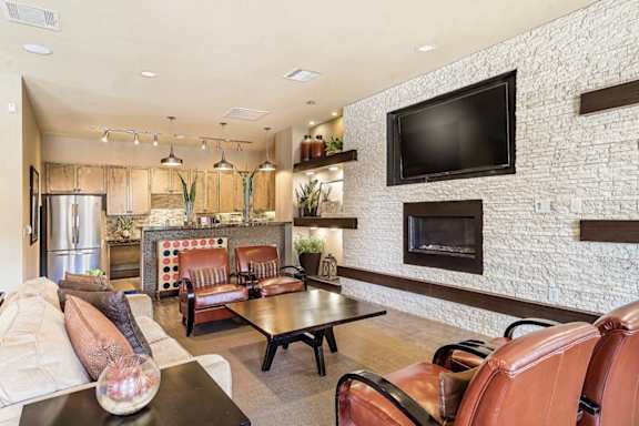 A living room with a fireplace and a television mounted on the wall.