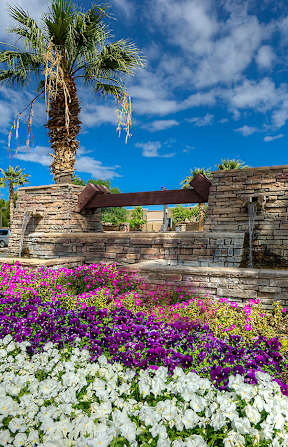 A large swimming pool surrounded by a resort-style building.