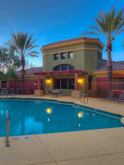 A house with a fountain in front of it.