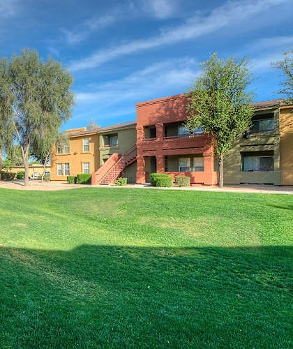 A grassy courtyard surrounded by buildings.