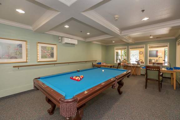a games room with a pool table and tables