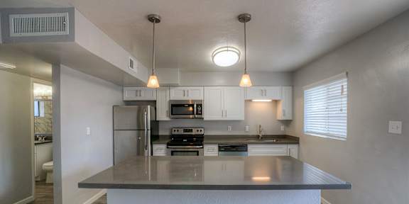 A kitchen with a large island in the middle.