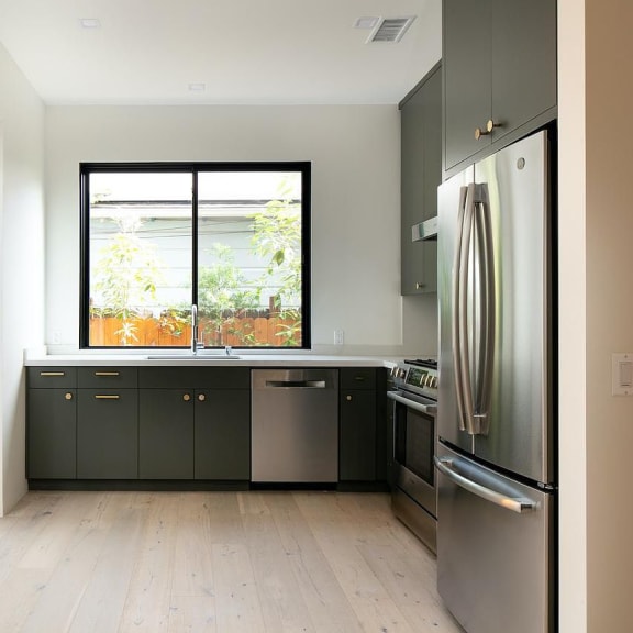 a kitchen with a stove top oven next to a window