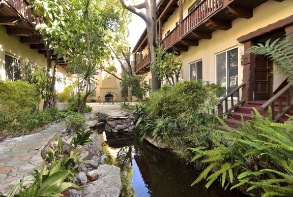 a courtyard with a water feature in front of a building