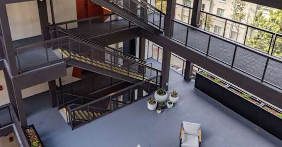 an overhead view of a lobby with chairs and a staircase