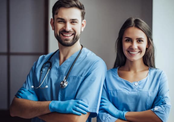 portrait of a young couple of doctors in blue scrubs