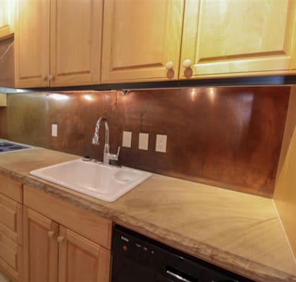 a kitchen with wooden cabinets and a white sink