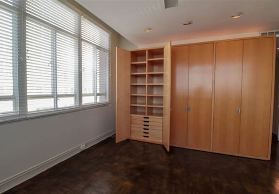 a bedroom with a wardrobe and a window